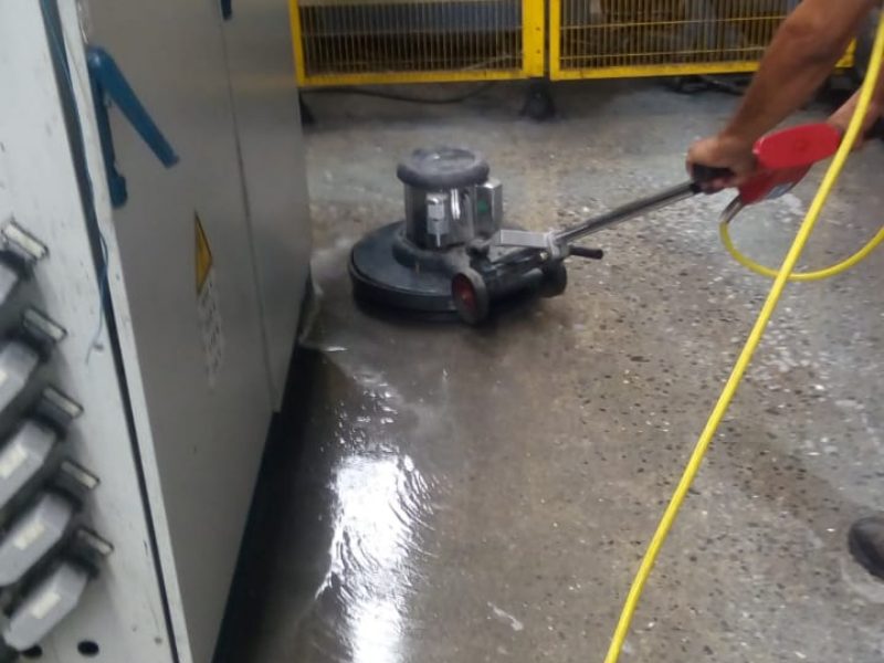 Pulido de piso con equipo en una planta industrial